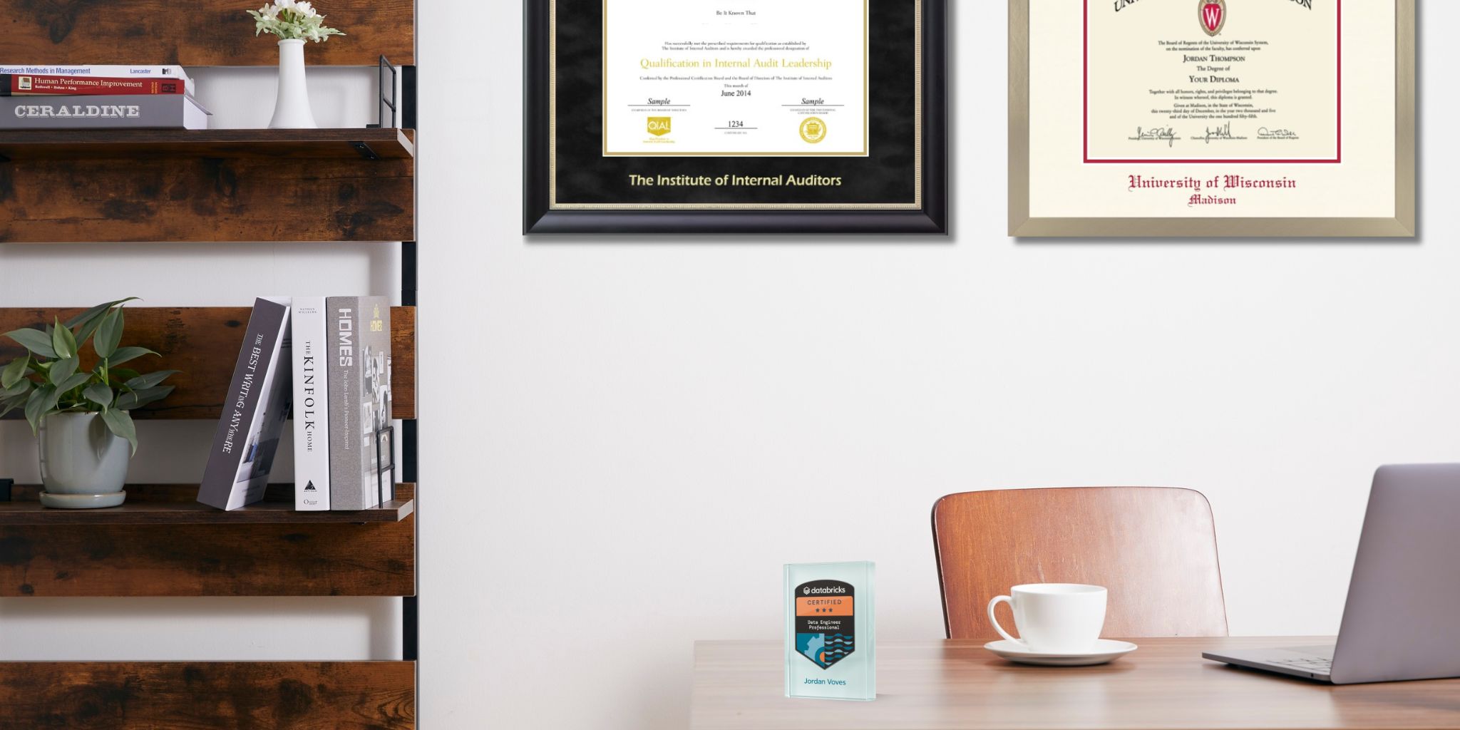 Office space featuring The Institute of Internal Auditors certificate frame and a University of Wisconsin Madison diploma frame on the wall and a Databricks digital badge on the desk next to a white coffee cup.