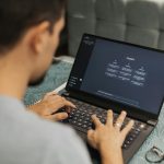 Person typing on a laptop that says "ChatGPT" on the screen.