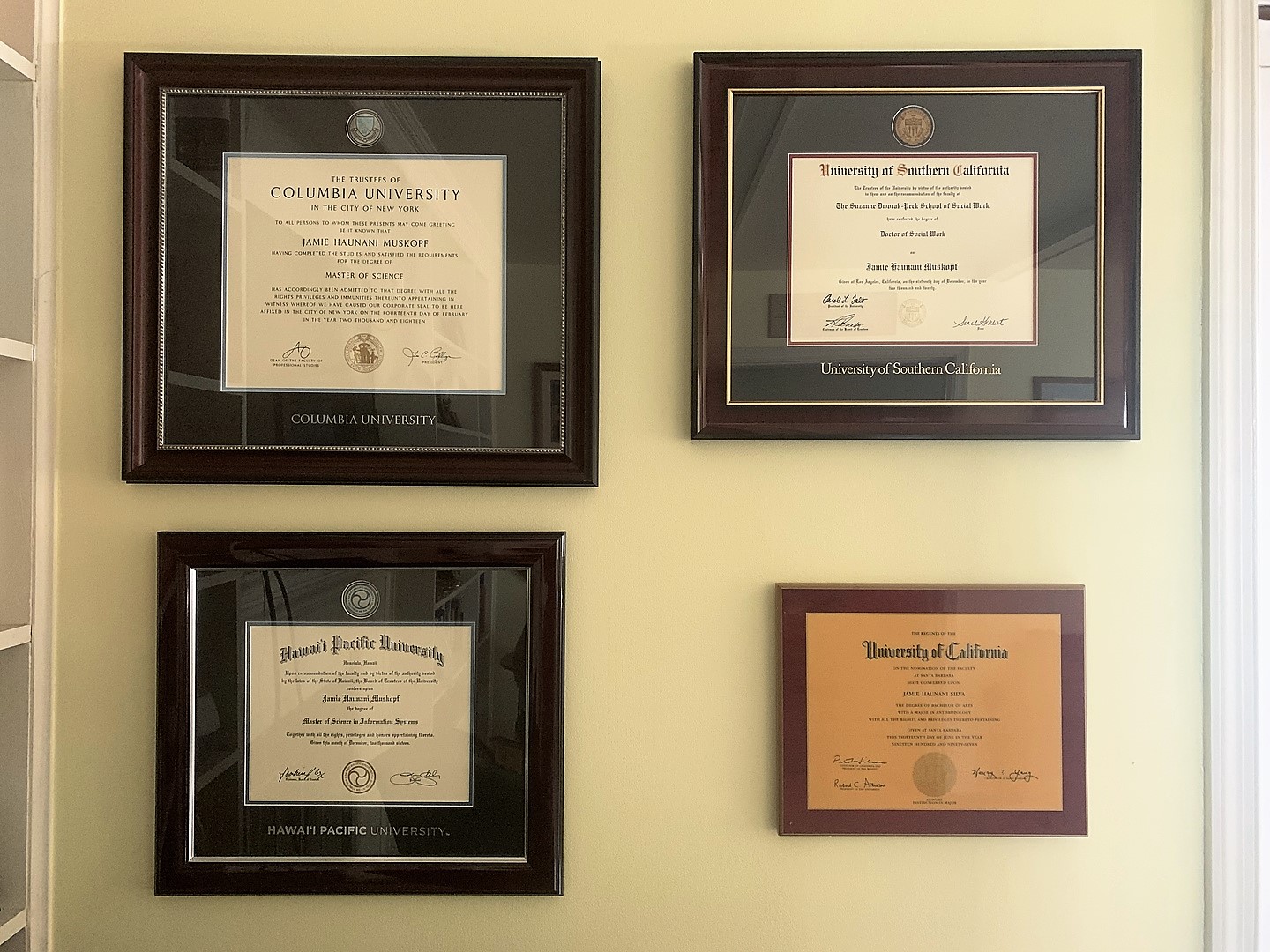 museum-quality frames next to cheap frame with yellow diploma