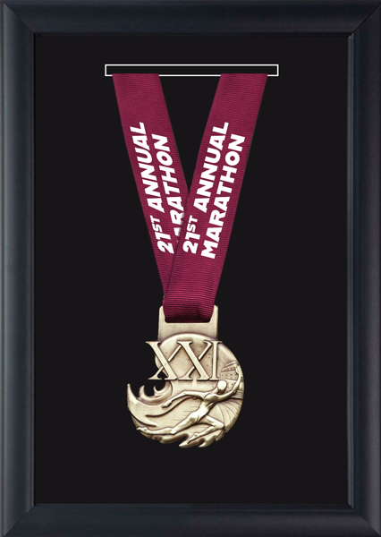 Framed marathon finisher medal with a maroon ribbon labeled ‘21st Annual Marathon’ mounted against a black background.