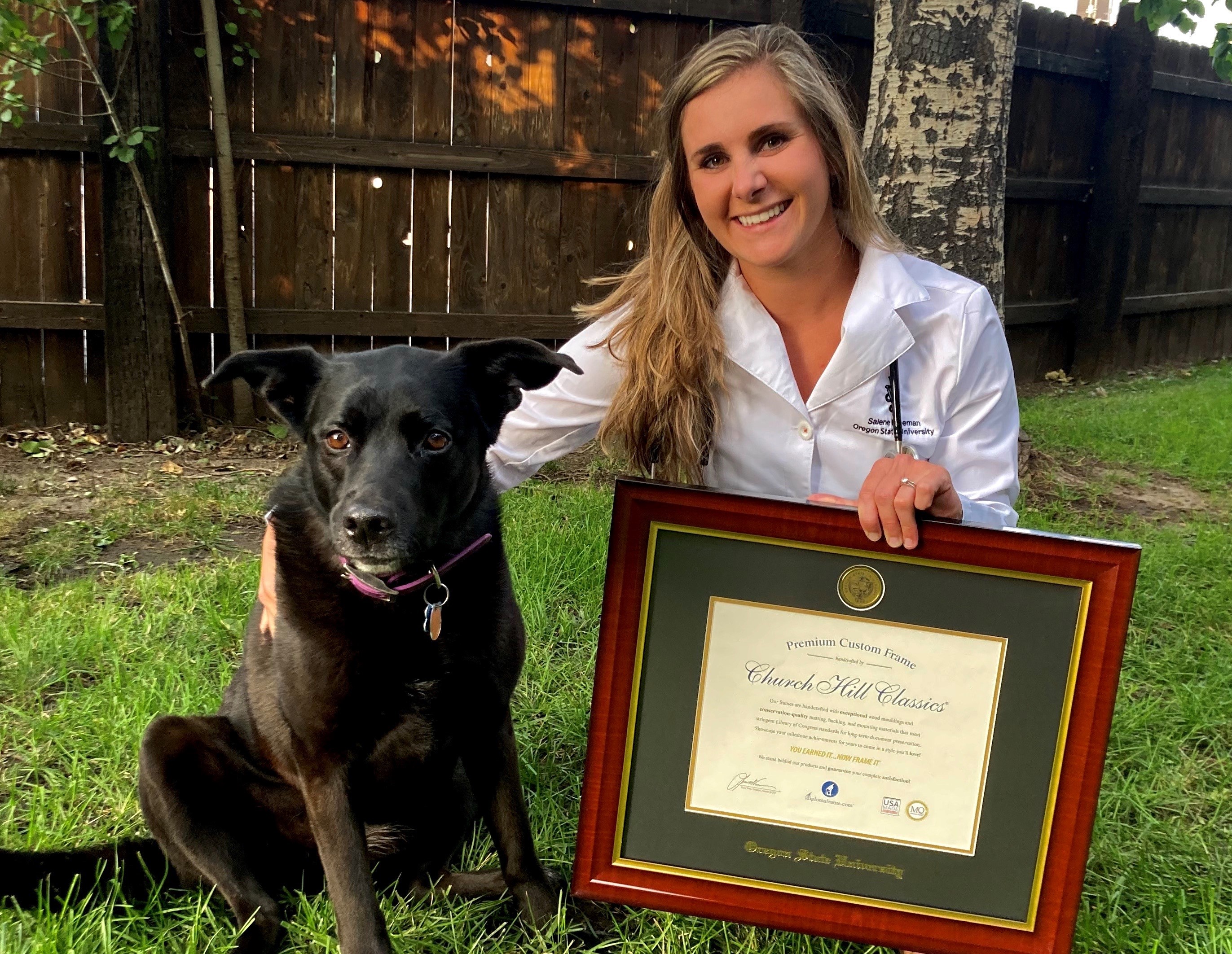 veterinarian and dog posing with Oregon State U frame