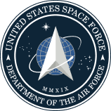 Official seal of the United States Space Force featuring a silver delta symbol, globe, stars, and orbital path on a dark blue circular background.