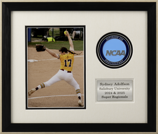 Framed softball action photo featuring a pitcher in a yellow uniform mid-throw, displayed with an NCAA Division III participant medallion and engraved nameplate.