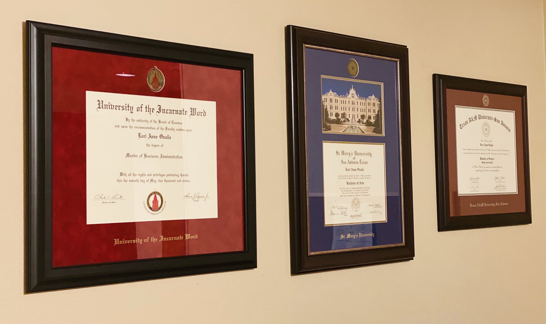 Three Diploma Frames On The Wall