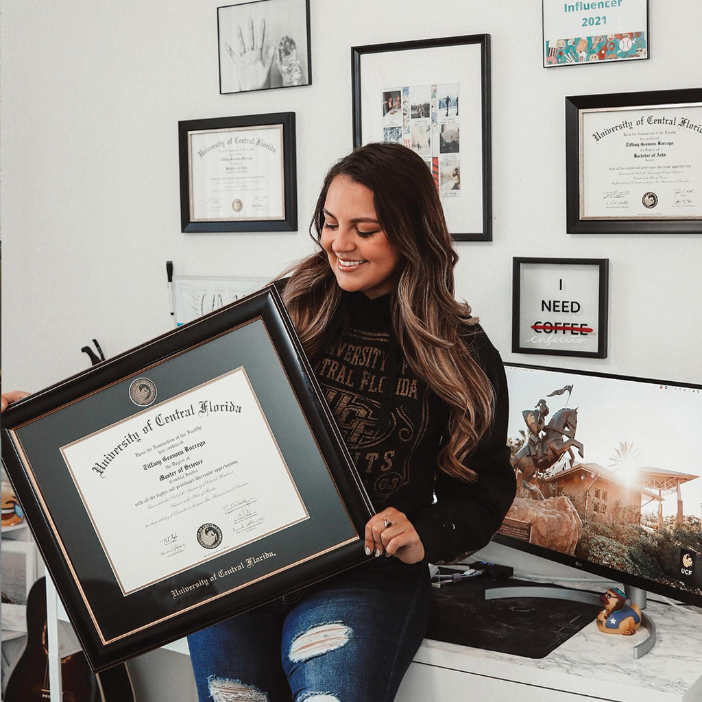 Graduated holding her University of Central Florida Masterpiece diploma frame