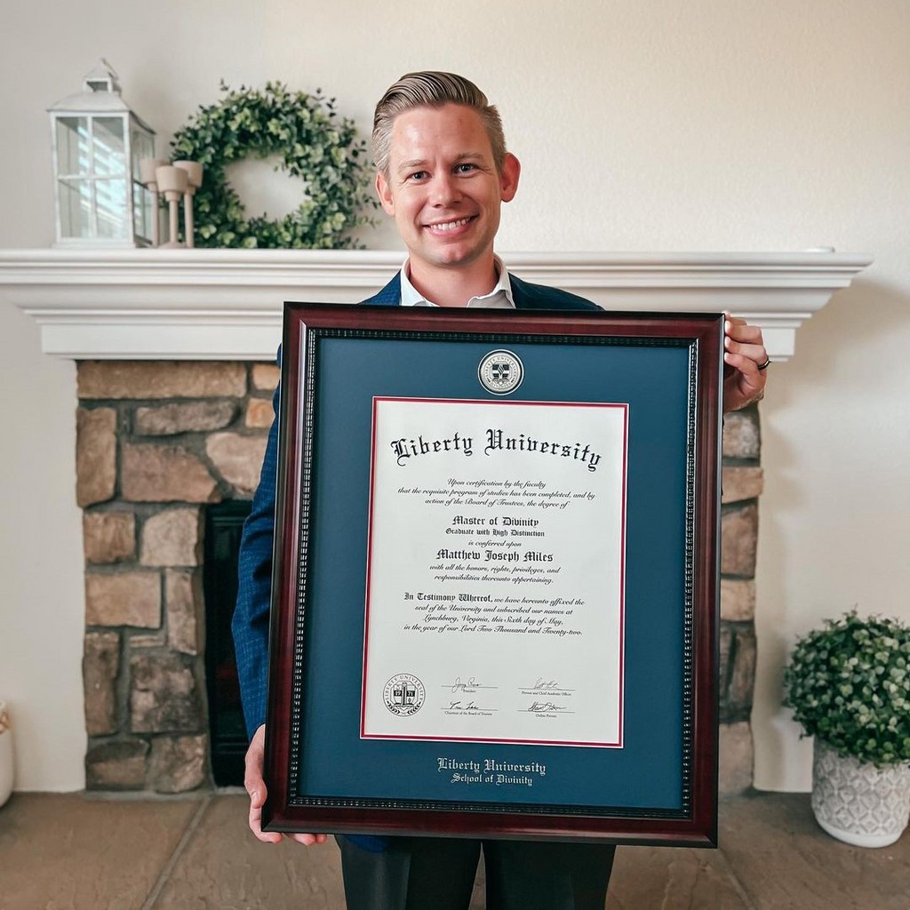 Man with Liberty University degree frame