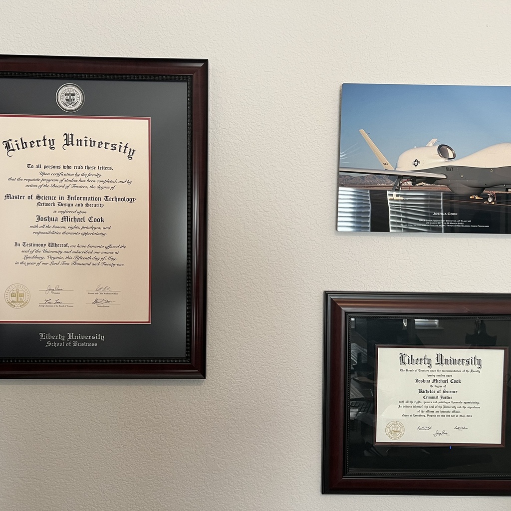 two liberty university diploma frames on wall