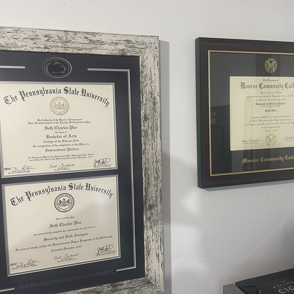 Penn State double diploma frame next to Monroe Community college frame