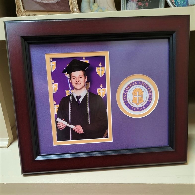 Concordia University photo frame with smiling graduate