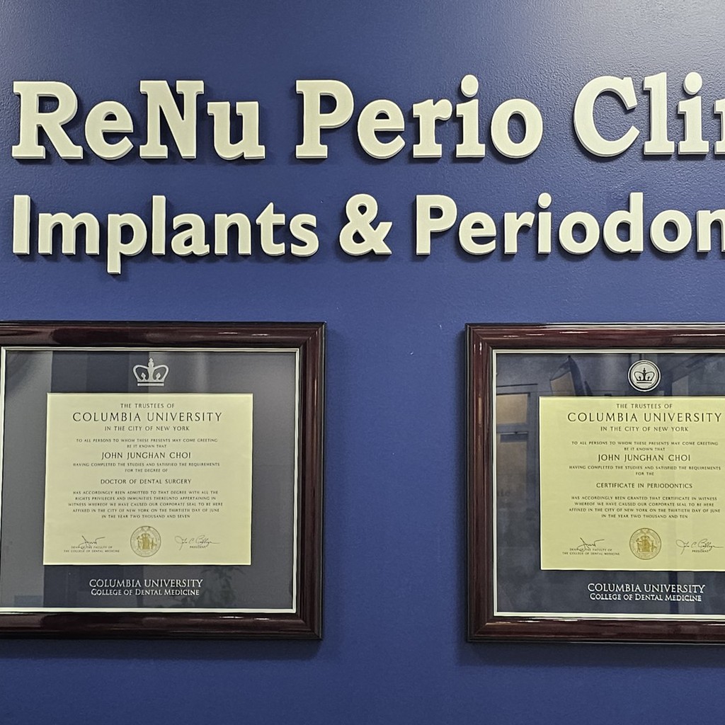 two Columbia University dental degrees on blue office wall