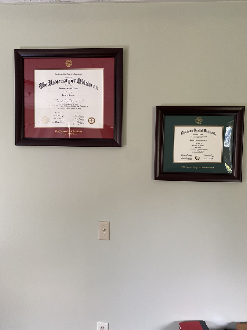 Oklahoma degree frames hanging on wall