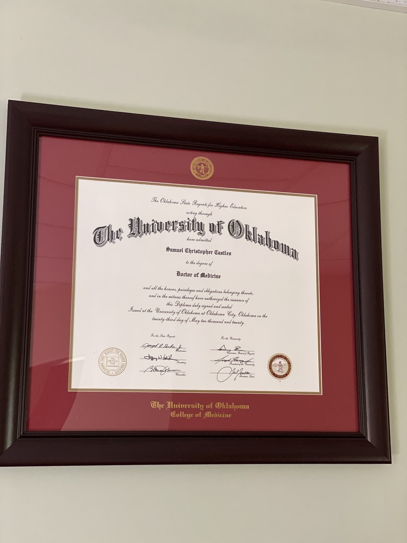 Red University of Oklahoma medical degree frame on wall