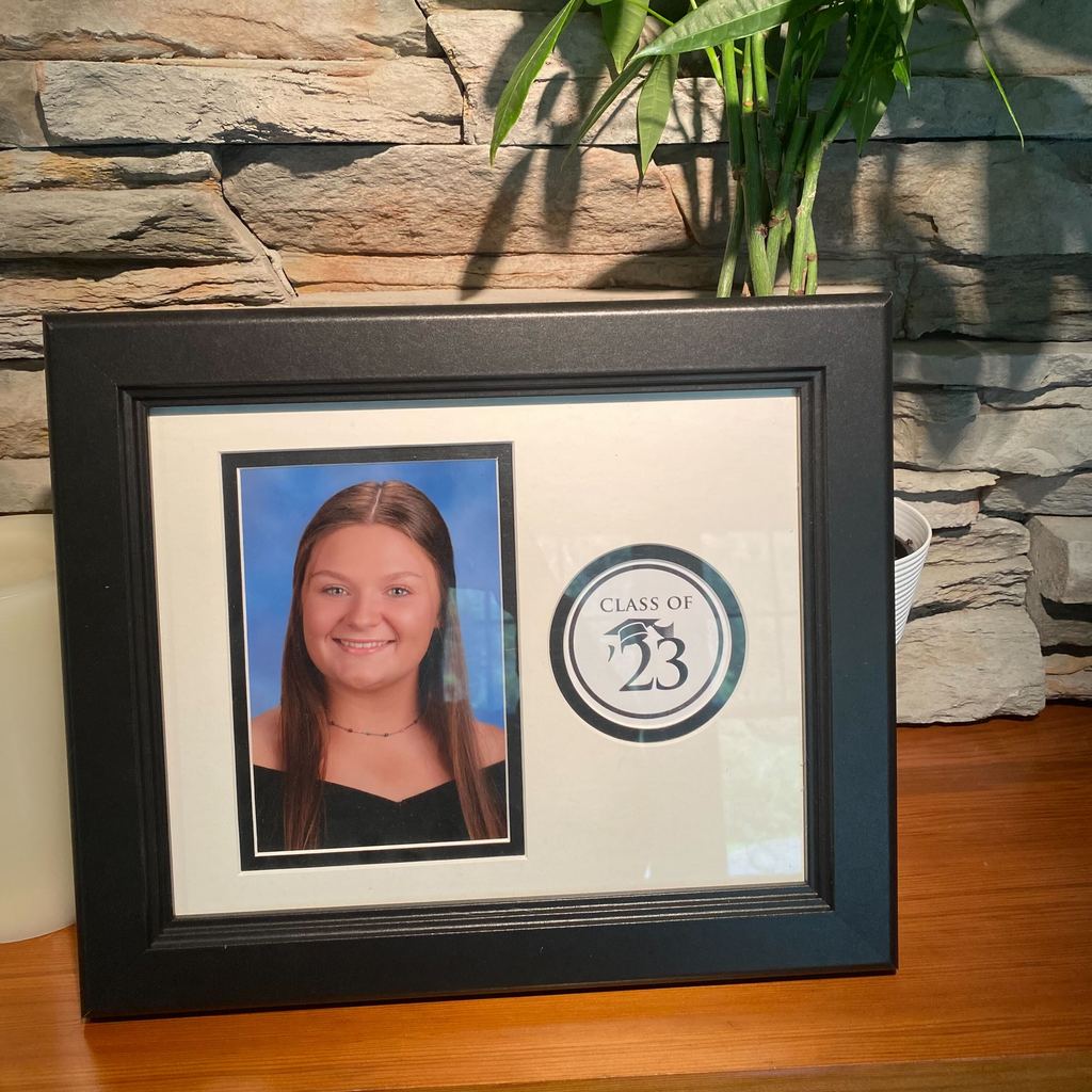 Class of 2023 photo frame with picture of smiling girl on mantle