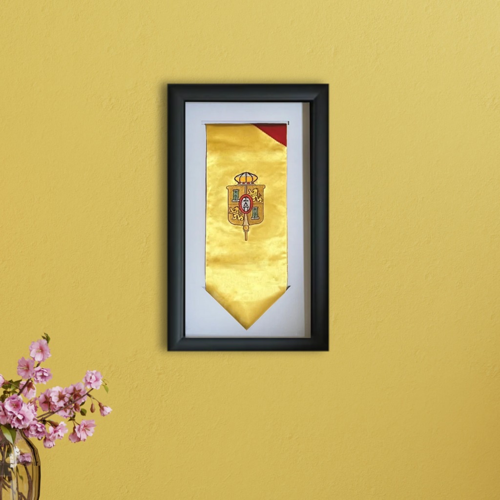 yellow honor society graduation stole in frame on yellow wall