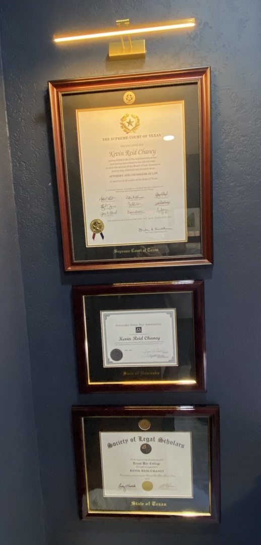 three state of texas document frames hung on a wall