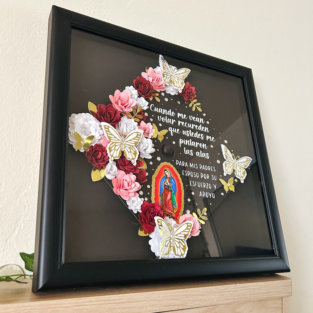 floral butterfly decorated grad cap frame on shelf