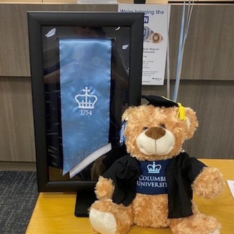 Columbia University stole frame next to grad teddy bear