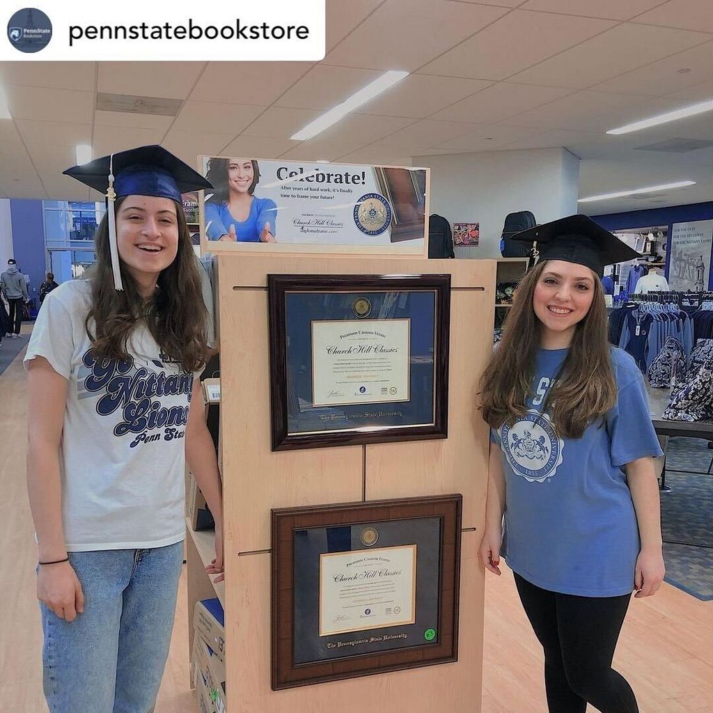 Students in bookstore wearing grad caps next to penn state diploma frames