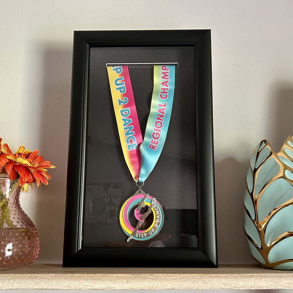 dance competition medallion in black shadow box frame