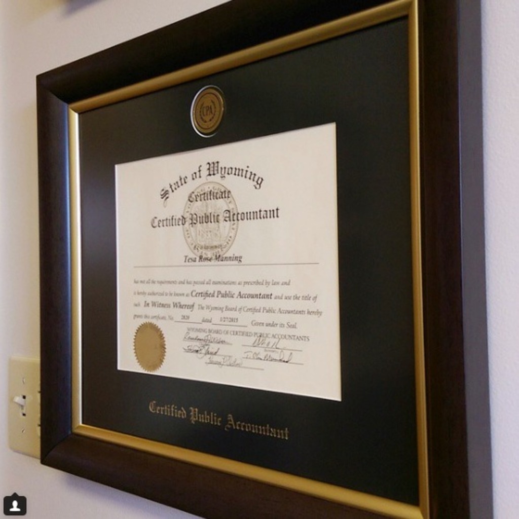Engraved CPA certificate frame hung on wall