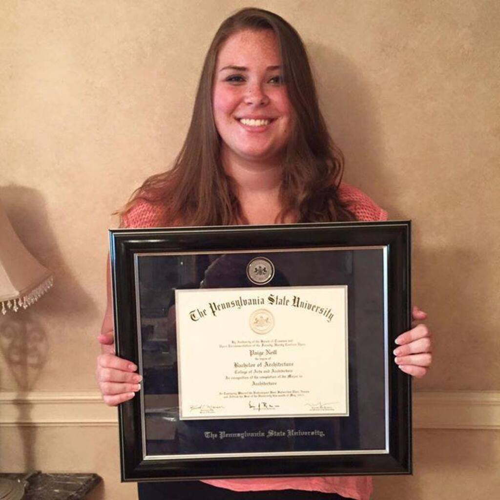 Woman holding Penn State diploma frame