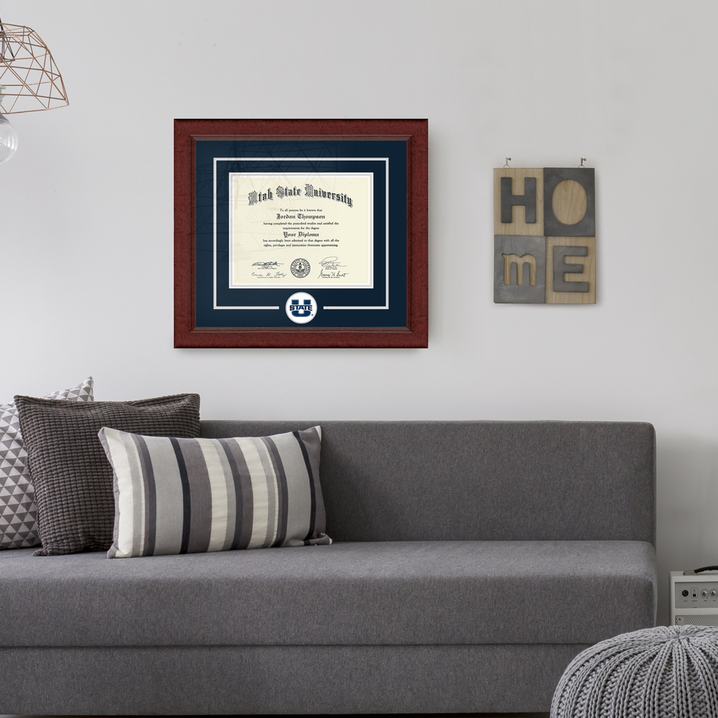 a living room with a Utah State University diploma frame hung on the wall