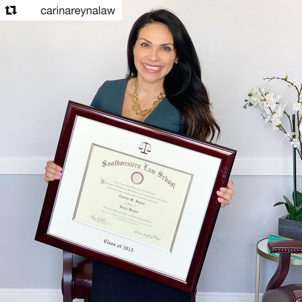 smiling woman holding a custom Church Hill Classics law certificate frame