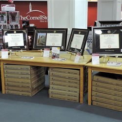 Cornell diploma frames displayed on tables at The Cornell Store