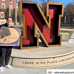 University of Nebraska Grad holding a Church Hill Classics frame box