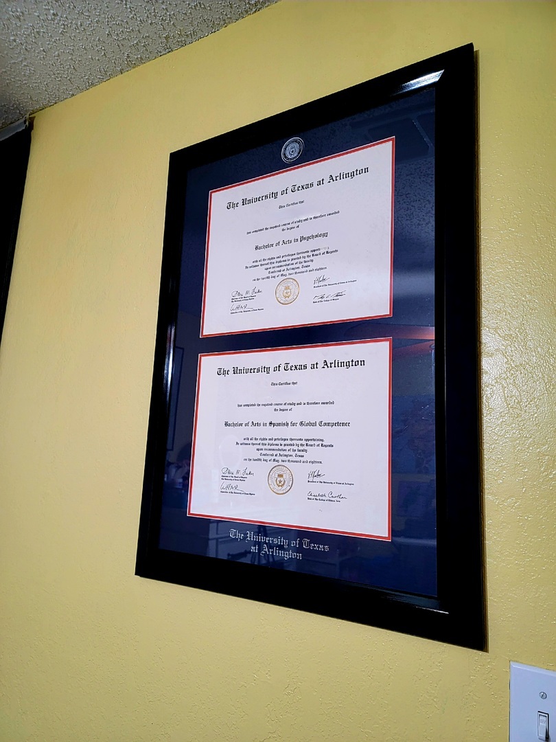 The University of Texas at Arlington dual degree frame hanging on yellow wall